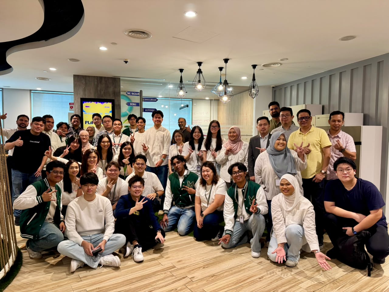 Agmo and Maxis team members posing together for a group photo at the Maxis AI First event